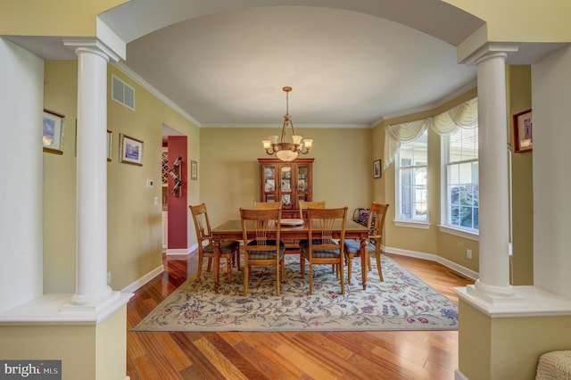 18 Knottingham Dr, Voorhees, NJ 08043 - dining space featuring decorative columns, wood finished floors, crown molding, and a chandelier