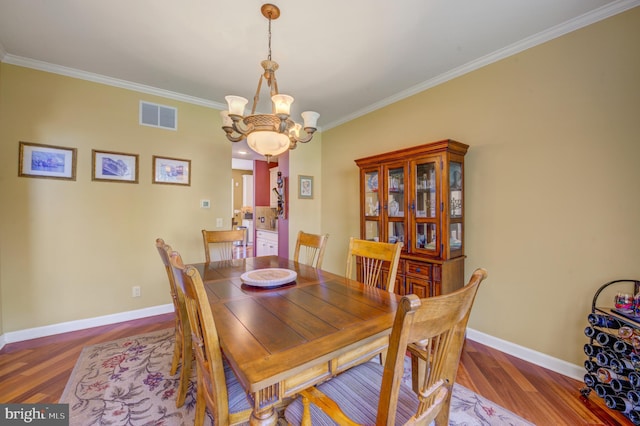 18 Knottingham Dr, Voorhees, NJ 08043 - dining space featuring ornamental molding, wood finished floors, and a chandelier