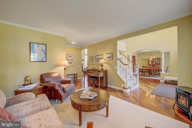 18 Knottingham Dr, Voorhees, NJ 08043 - living room with arched walkways, wood finished floors, a chandelier, stairway, and ornamental molding