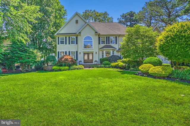 18 Knottingham Dr, Voorhees, NJ 08043 - view of front facade with a front yard, stucco siding, and french doors