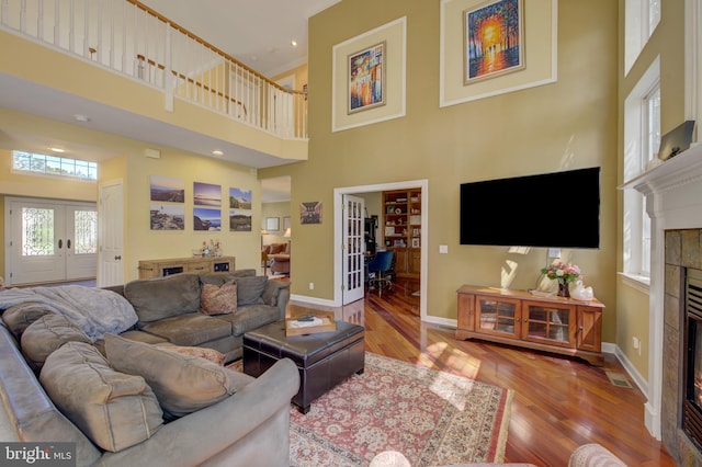 18 Knottingham Dr, Voorhees, NJ 08043 - living room with french doors, a tiled fireplace, wood finished floors, and a towering ceiling