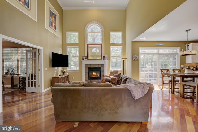 18 Knottingham Dr, Voorhees, NJ 08043 - living area featuring a tile fireplace, wood finished floors, a towering ceiling, and ornamental molding