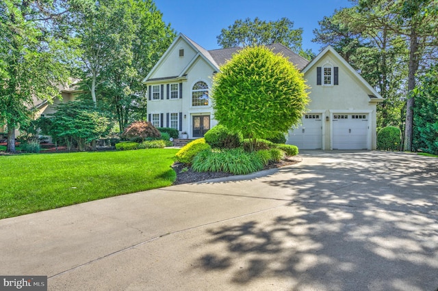 18 Knottingham Dr, Voorhees, NJ 08043 - view of front of home with stucco siding, french doors, a garage, a front yard, and concrete driveway
