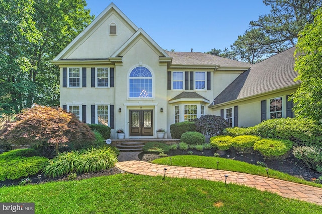 18 Knottingham Dr, Voorhees, NJ 08043 - view of front of property featuring french doors, stucco siding, a front lawn, and roof with shingles