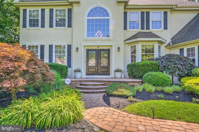 18 Knottingham Dr, Voorhees, NJ 08043 - property entrance with french doors, stucco siding, and roof with shingles