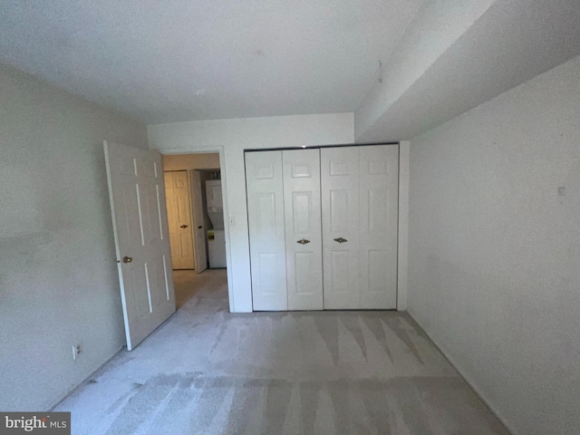 7630 Provincial Dr Unit 307, Mclean, VA 22102 - unfurnished bedroom featuring light colored carpet, estacked washer and dryer, and a closet