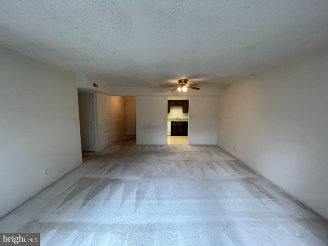 7630 Provincial Dr Unit 307, Mclean, VA 22102 - unfurnished living room featuring a ceiling fan, light colored carpet, and a textured ceiling