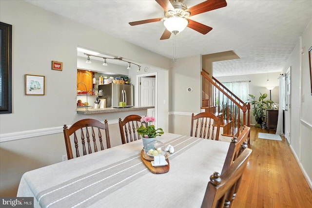 8141 Gray Haven Rd, Baltimore, MD 21222 - dining space featuring light wood-type flooring, stairway, and a ceiling fan