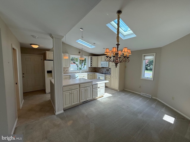127 Winding Hill Dr, Lancaster, PA 17601 - kitchen featuring a skylight, white appliances, a chandelier, lofted ceiling, and plenty of natural light