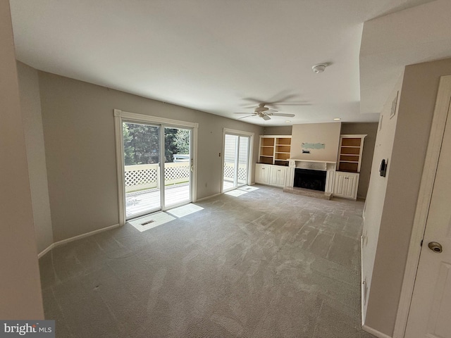 127 Winding Hill Dr, Lancaster, PA 17601 - unfurnished living room with a fireplace with raised hearth, ceiling fan, and carpet flooring