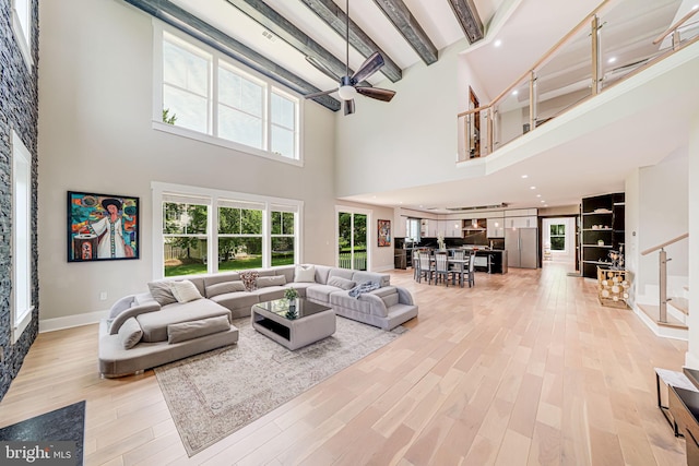 9908 Blake Ln, Oakton, VA 22124 - living area with a high ceiling, light wood-style floors, beamed ceiling, and a ceiling fan