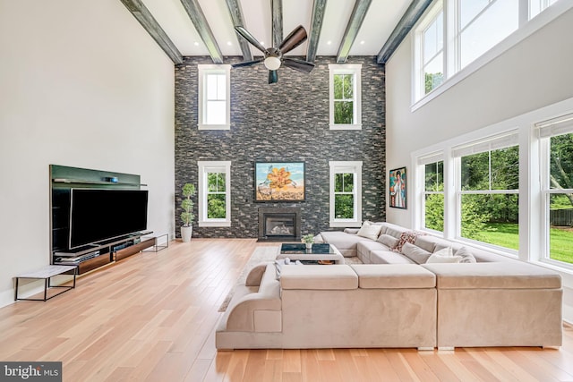 9908 Blake Ln, Oakton, VA 22124 - living room with wood finished floors, a towering ceiling, a fireplace, beamed ceiling, and ceiling fan