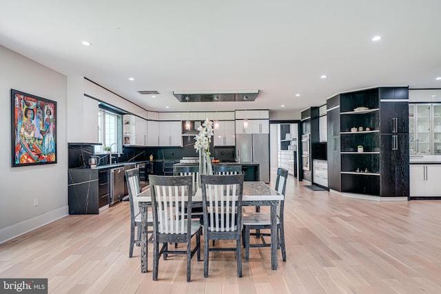 9908 Blake Ln, Oakton, VA 22124 - dining room with light wood-style flooring and recessed lighting