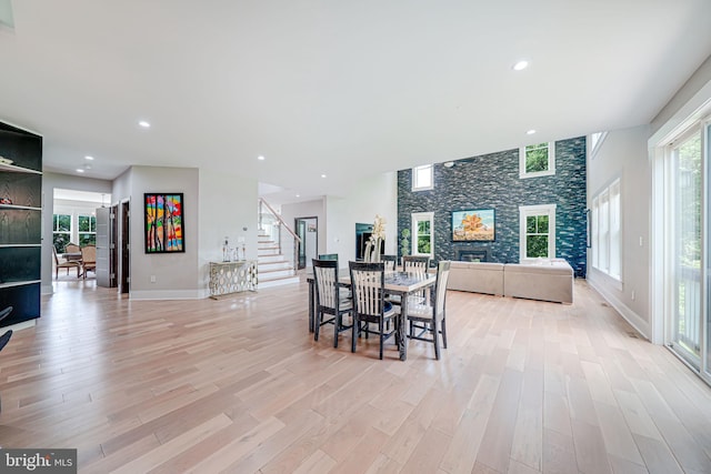 9908 Blake Ln, Oakton, VA 22124 - dining area with stairs, light wood-type flooring, a fireplace, and recessed lighting