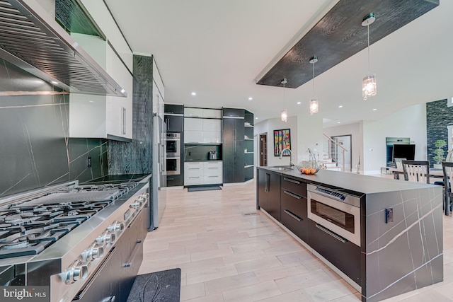 9908 Blake Ln, Oakton, VA 22124 - kitchen featuring modern cabinets, stainless steel appliances, decorative backsplash, extractor fan, and recessed lighting