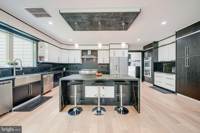 9908 Blake Ln, Oakton, VA 22124 - kitchen featuring wall chimney exhaust hood, stainless steel appliances, modern cabinets, open shelves, and tasteful backsplash