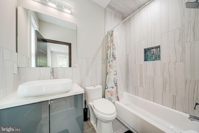 9908 Blake Ln, Oakton, VA 22124 - full bathroom featuring tile walls, vanity, shower / bathtub combination with curtain, and tile patterned flooring