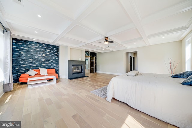 9908 Blake Ln, Oakton, VA 22124 - bedroom with light wood-style floors, coffered ceiling, a glass covered fireplace, beamed ceiling, and ceiling fan