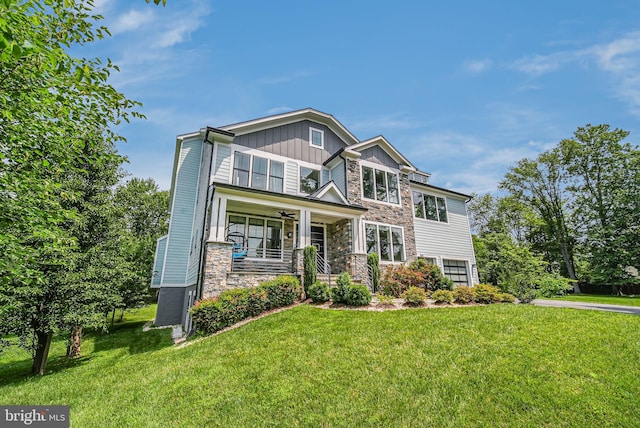9908 Blake Ln, Oakton, VA 22124 - craftsman house featuring board and batten siding, covered porch, stone siding, and a front yard