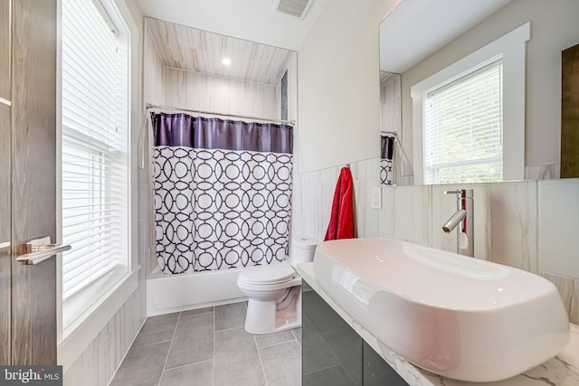 9908 Blake Ln, Oakton, VA 22124 - full bathroom featuring shower / bathtub combination with curtain, tile patterned flooring, and a wainscoted wall