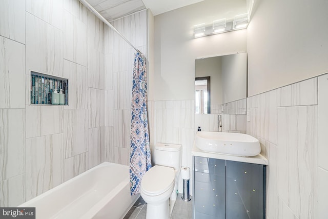 9908 Blake Ln, Oakton, VA 22124 - bathroom with tile walls, vanity, and shower / tub combo with curtain