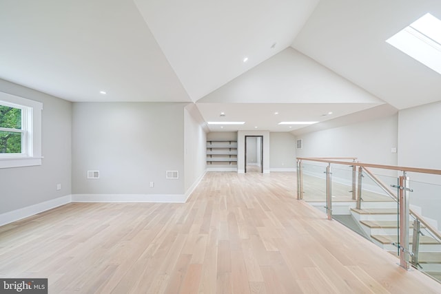9908 Blake Ln, Oakton, VA 22124 - unfurnished room with light wood-style floors, a skylight, recessed lighting, and lofted ceiling