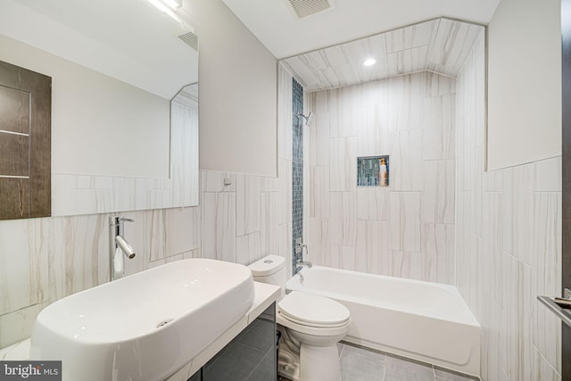 9908 Blake Ln, Oakton, VA 22124 - full bathroom featuring tile walls,  shower combination, recessed lighting, and tile patterned flooring