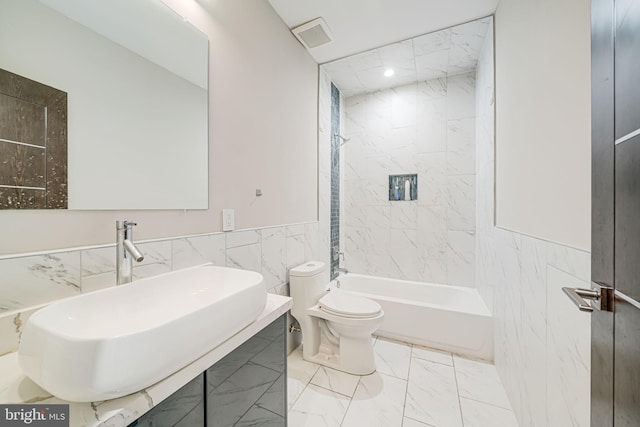 9908 Blake Ln, Oakton, VA 22124 - full bath featuring marble finish flooring, tile walls, a wainscoted wall, washtub / shower combination, and vanity