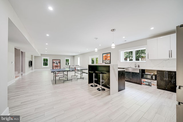 9908 Blake Ln, Oakton, VA 22124 - kitchen featuring recessed lighting, backsplash, a kitchen island, white cabinets, and plenty of natural light