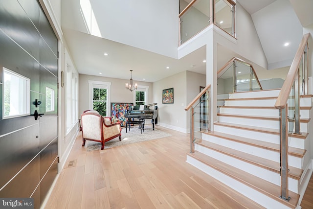 9908 Blake Ln, Oakton, VA 22124 - staircase with wood finished floors, a chandelier, recessed lighting, and a high ceiling
