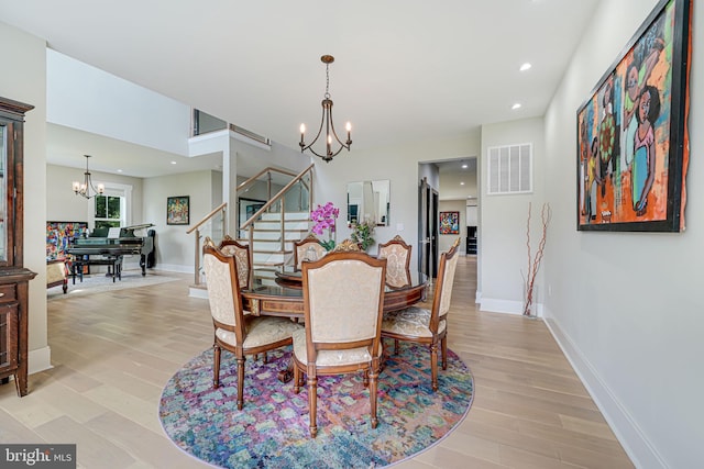 9908 Blake Ln, Oakton, VA 22124 - dining area featuring a chandelier, stairway, light wood finished floors, and recessed lighting