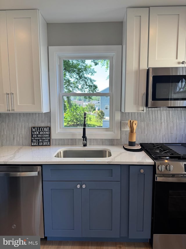 512 Majestic Ave, Bellmawr, NJ 08031 - kitchen featuring stainless steel appliances, tasteful backsplash, white cabinets, and blue cabinets