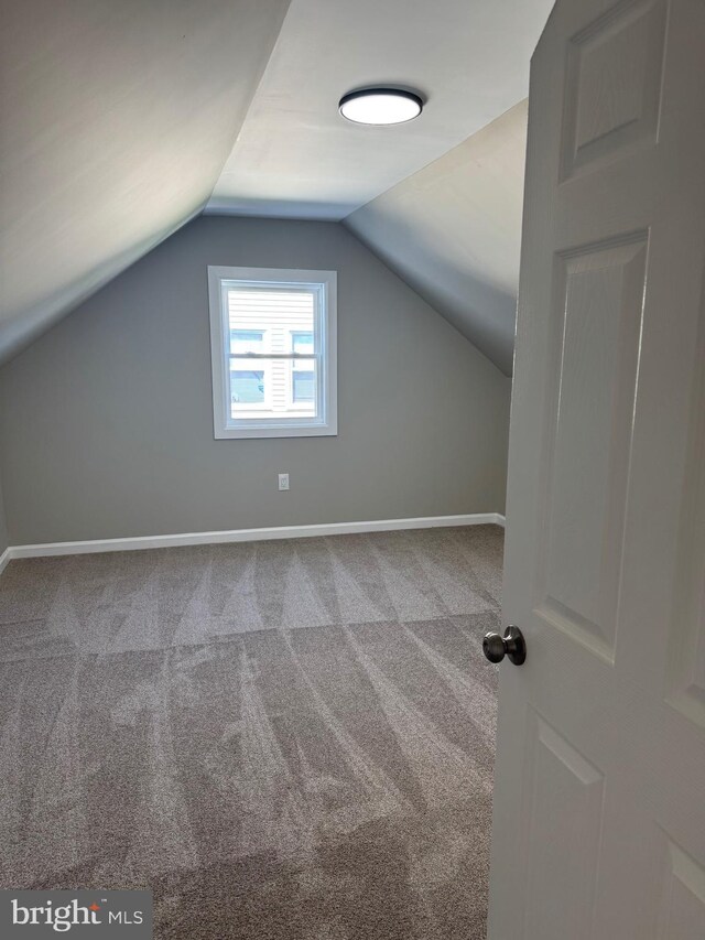 512 Majestic Ave, Bellmawr, NJ 08031 - additional living space with carpet floors and vaulted ceiling