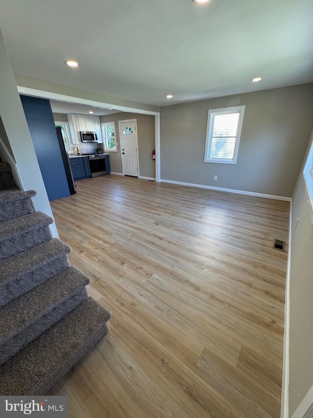 512 Majestic Ave, Bellmawr, NJ 08031 - unfurnished living room featuring stairs, recessed lighting, and light wood finished floors
