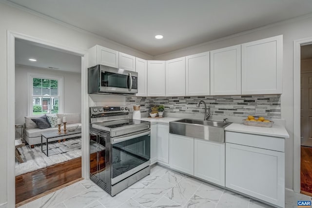 1623 Mason Ln, Charlottesville, VA 22903 - kitchen with stainless steel appliances, light countertops, white cabinets, light marble finish flooring, and recessed lighting