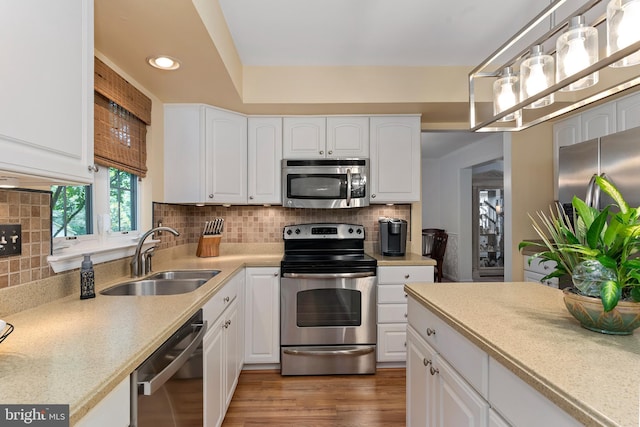 6 Thunder Gulch, Newark, DE 19702 - kitchen featuring stainless steel appliances, white cabinets, light countertops, decorative backsplash, and recessed lighting