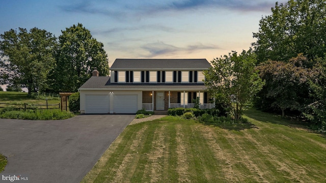 1395 Buckhorn Rd, Sykesville, MD 21784 - colonial home with a porch, asphalt driveway, a chimney, and a garage