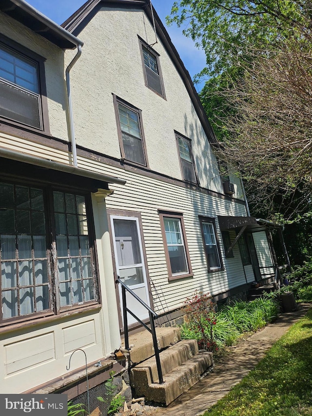 409 W Beechtree Ln, Wayne, PA 19087 - view of property exterior featuring stucco siding and entry steps