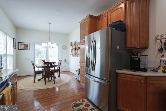 802 Geranium Dr, Warrington, PA 18976 - kitchen with stainless steel appliances, a chandelier, brown cabinetry, and light countertops
