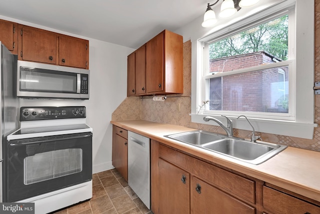 12 Charlestown Rd, Washington Boro, PA 17582 - kitchen with stainless steel appliances, light countertops, tasteful backsplash, and brown cabinetry