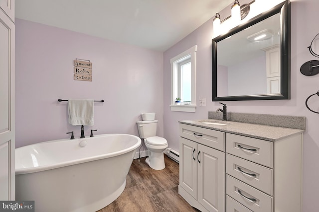 12 Charlestown Rd, Washington Boro, PA 17582 - bathroom featuring a baseboard radiator, wood finished floors, a freestanding tub, and vanity