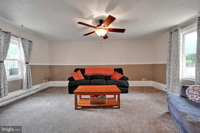 12 Charlestown Rd, Washington Boro, PA 17582 - carpeted living area with healthy amount of natural light, a ceiling fan, baseboard heating, and a textured ceiling