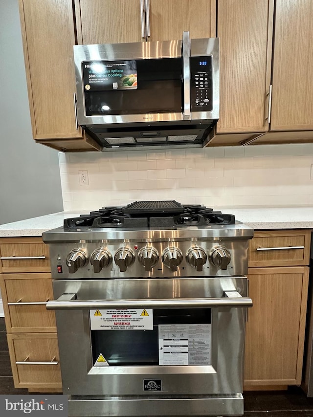 2937 N Judson St, Philadelphia, PA 19132 - detailed view of stainless steel appliances, light countertops, and decorative backsplash
