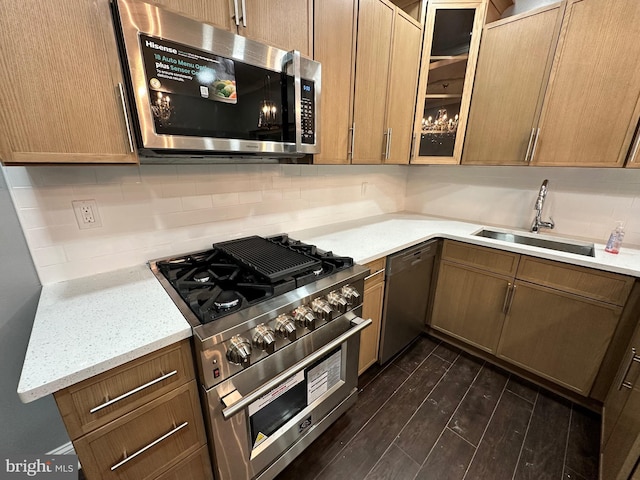 2937 N Judson St, Philadelphia, PA 19132 - kitchen featuring appliances with stainless steel finishes, tasteful backsplash, dark wood-style floors, glass insert cabinets, and light stone countertops