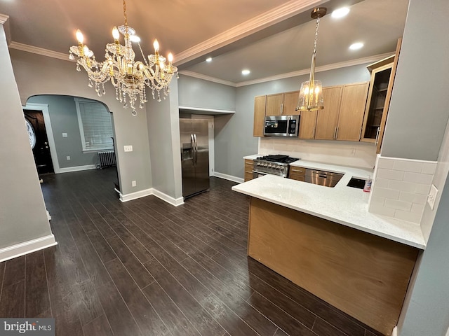 2937 N Judson St, Philadelphia, PA 19132 - kitchen with stainless steel appliances, arched walkways, a chandelier, crown molding, and glass insert cabinets