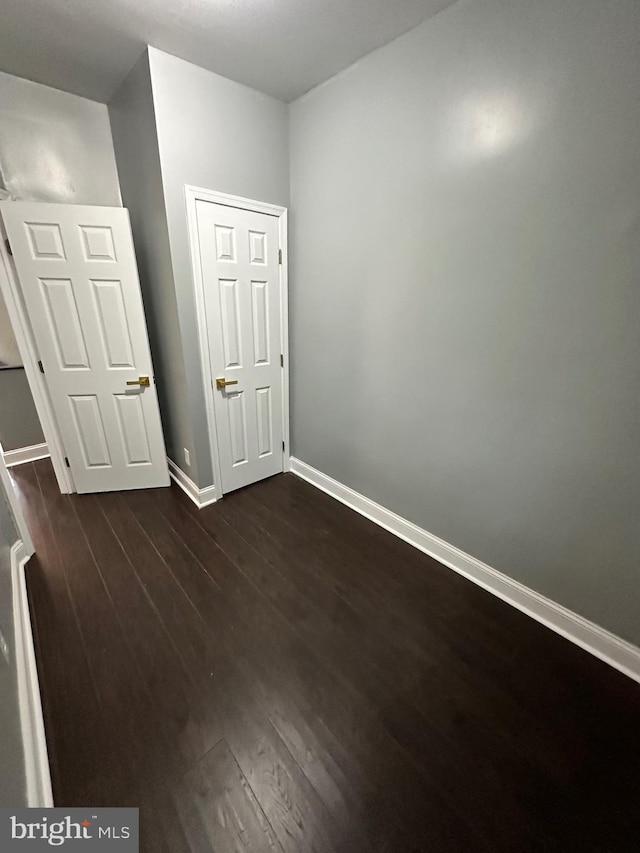 2937 N Judson St, Philadelphia, PA 19132 - unfurnished bedroom with dark wood-style floors and baseboards