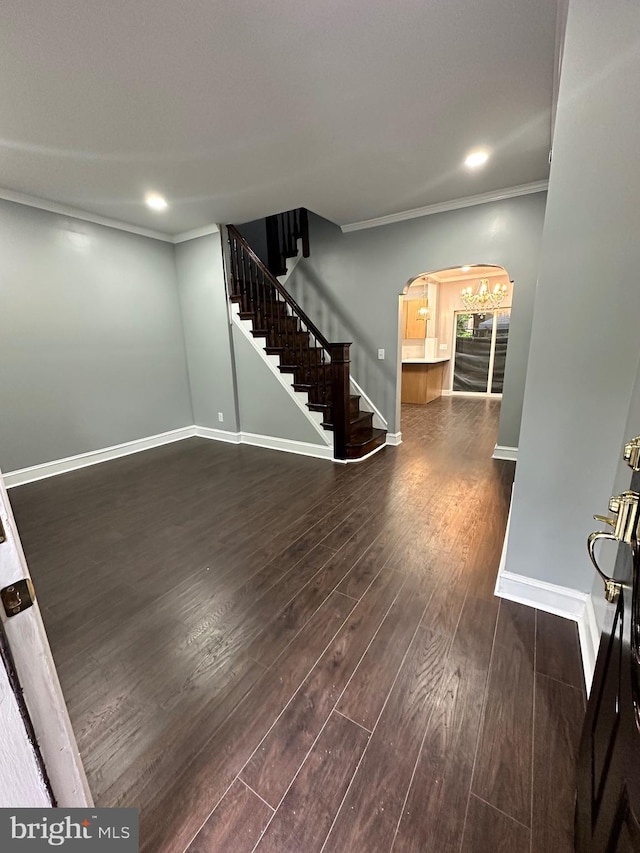 2937 N Judson St, Philadelphia, PA 19132 - foyer entrance featuring dark wood finished floors, stairway, arched walkways, ornamental molding, and recessed lighting