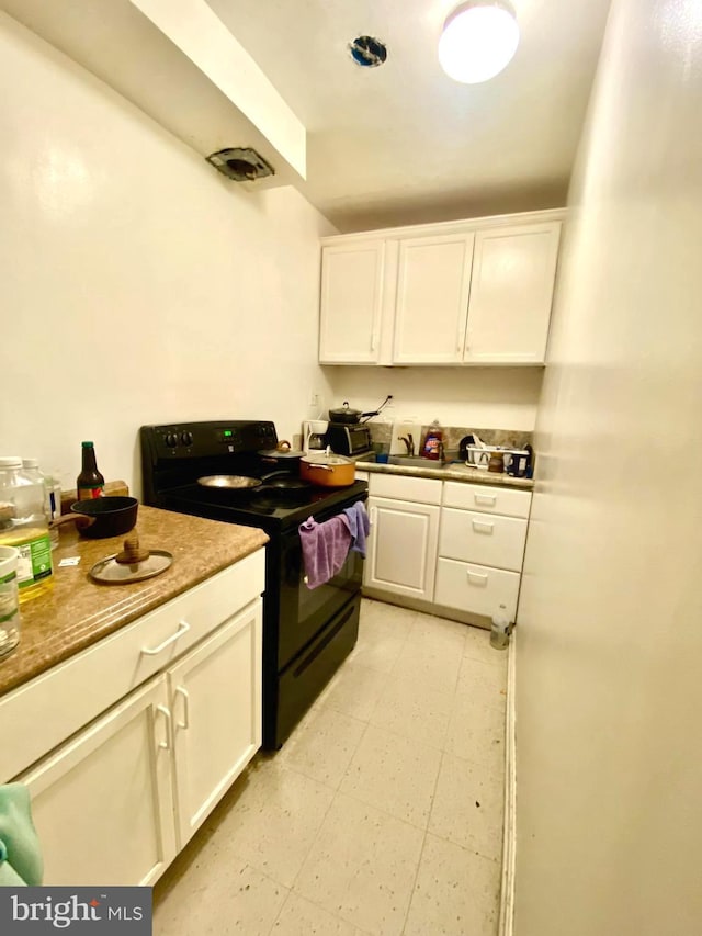1064 W W Side Dr Unit 25-F, Gaithersburg, MD 20878 - kitchen featuring black electric range, white cabinetry, and light flooring