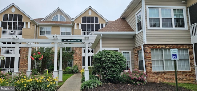 306 Canterbury Rd Unit 306-O, Bel Air, MD 21014 - entrance to property with brick siding, a pergola, and roof with shingles