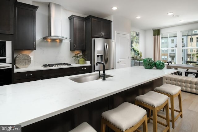 3453 Saint Robin Ln, Bowie, MD 20716 - kitchen featuring wall chimney range hood, appliances with stainless steel finishes, recessed lighting, light wood-style flooring, and tasteful backsplash